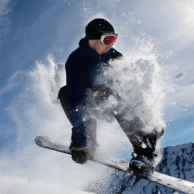 male-snowboarding-on-mountain